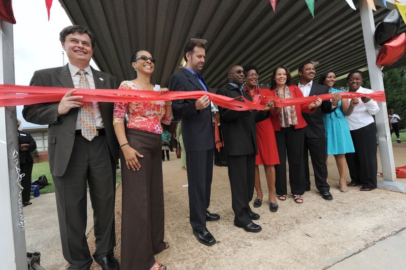 Community leaders, government officials and board members of the DeKalb Preparatory Academy cut a red ribbon to officially open the school in August 2012. (AJC file photo)