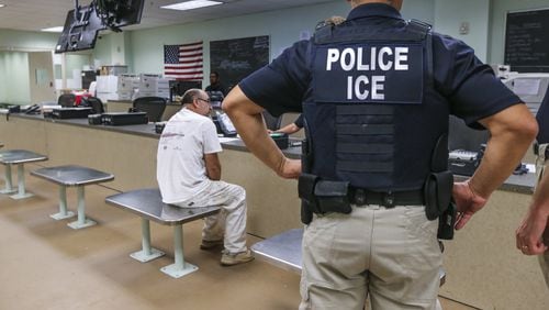 U.S. Immigration and Customs Enforcement officers detaining a Mexican national in Atlanta, Aug. 18, 2017. JOHN SPINK/JSPINK@AJC.COM