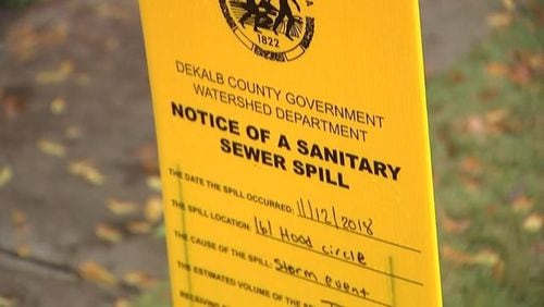 <p>Workers putting down lime after sewage spills in DeKalb County</p> <p>Signs indicating a sewer spill in DeKalb County</p>