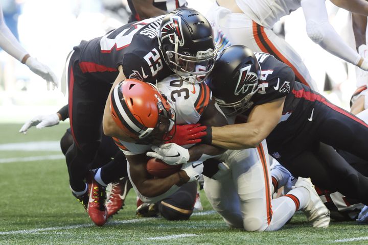 Falcons linebacker Troy Andersen (44) and safety Erik Harris stop Browns running back Nick Chubb during the second quarter Sunday at Mercedes-Benz Stadium. (Miguel Martinez / miguel.martinezjimenez@ajc.com)