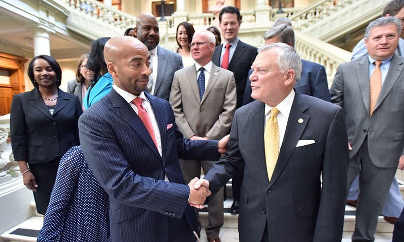 MARTA CEO and General Manager Keith Parker (left) and Gov. Nathan Deal greet after an announcement of $100 million in state-funded transit projects at The Georgia State Capitol in June 2016. (HYOSUB SHIN / HSHIN@AJC.COM)