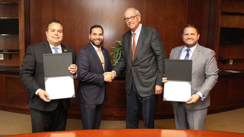 Santiago Marquez, left, resigned from the elections board shortly after being appointed. He's pictured with Antonio Molina from the Georgia Hispanic Chamber of Commerce and Tom Andersen and Nick Masino (president and CEO). COURTESY GWINNETT CHAMBER/AJC FILE PHOTO