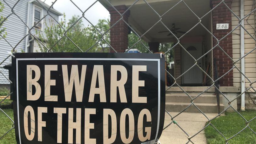 Two dogs were euthanized after attacking three people in Lawrenceville on Monday.