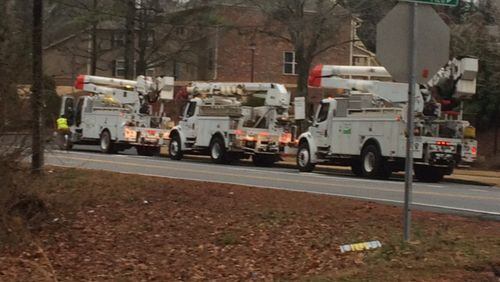 Power crews respond to an outage in the area of Buford Highway and Suwanee Creek Road in Suwanee, Ga. Photo by Christian Boone/STAFF