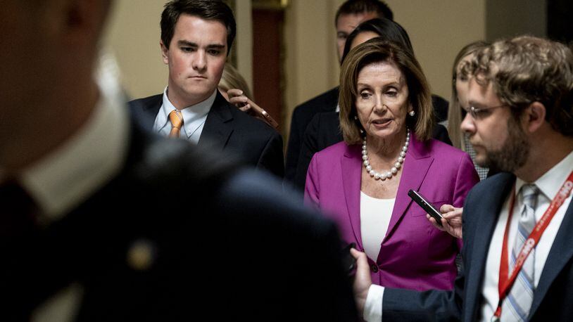 Speaker Nancy Pelosi, D-Cal., speaks to reporters as she makes her way to the U.S. House chamber to vote on a resolution denouncing comments by President Trump targeting four progressive Democratic congresswomen of color. Pete Marovich/Getty Images