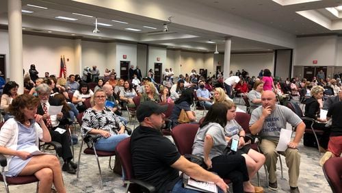 Scores of audience members refused to wear masks or leave the Gwinnett County Board of Education meeting on May 20, 2021. (ALI MALK / AJC)
