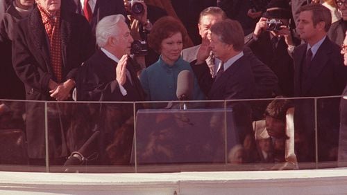 Jimmy Carter takes the oath of office, as his wife, Rosalynn, holds the family bible, during the inauguration ceremony in January of 1977. Administrating the oath is Chief Justice of the U.S. Warren Burger. Looking on, from left, are: outgoing President Gerald Ford, and at right, Vice President Walter Mondale, and former Vice President Nelson Rockefeller. (Associated Press)