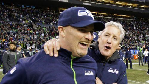 Seattle Seahawks head coach Pete Carroll, right, celebrates with defensive coordinator Dan Quinn, left, after they defeated the St. Louis Rams 20-6 in an NFL football game, Sunday, Dec. 28, 2014, in Seattle. (AP Photo/Scott Eklund) Dan Quinn, here with Seattle head coach Pete Carroll, should still be Falcons' top choice. (AP photo)