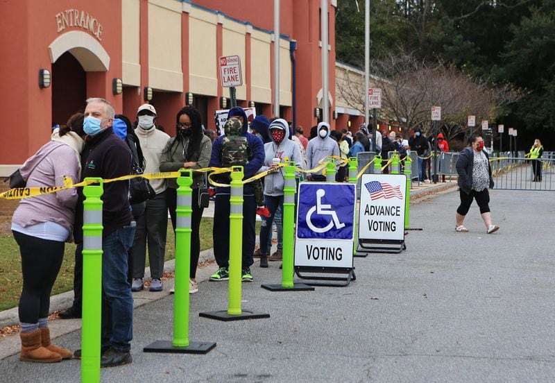 People wait in line for early voting in October at the Cobb County Tax Commissioner Office in Marietta. The county initially reduced the number of early voting sites for the Jan. 5 U.S. Senate runoffs from 11 to five. After concerns were raised, though, the county added two more locations for the final week of early voting. CHRISTINA MATACOTTA FOR THE ATLANTA JOURNAL-CONSTITUTION.
