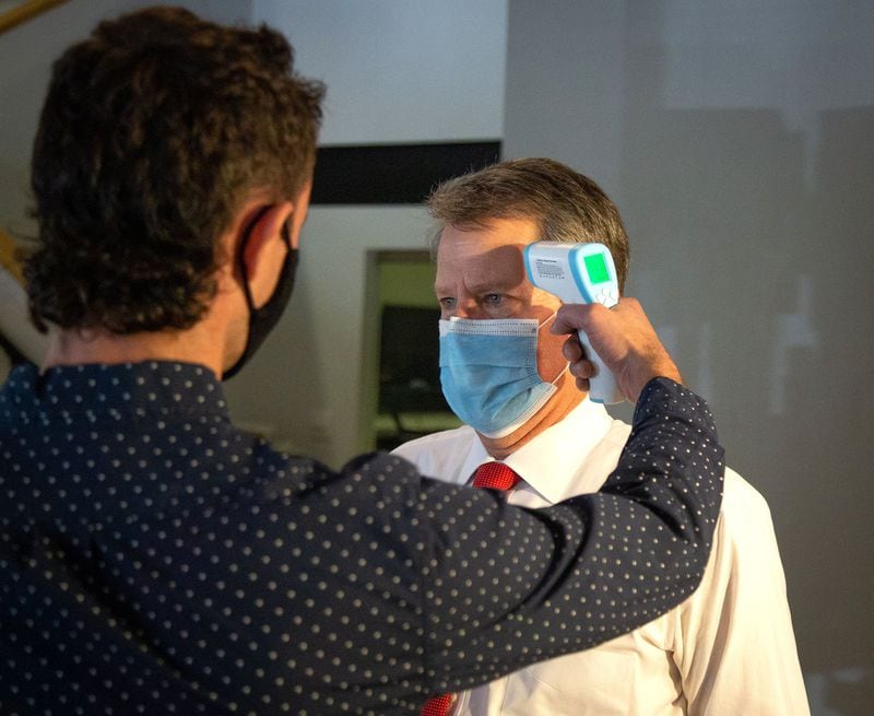 Gov.Brian Kemp gets his temperature checked before touring the Cutting Board Co. in Norcross on June 26, 2020. (Steve Schaefer for The Atlanta Journal-Constitution)