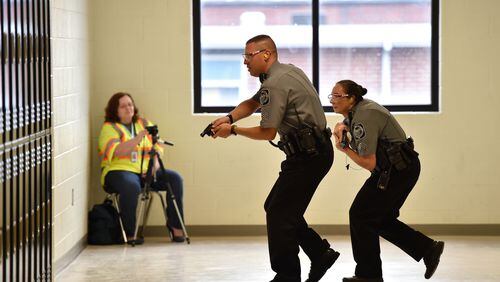 An active shooter drill performed by Villa Rica police officers at Villa Rica High School in October. Officials said drills are important tools to help reinforce disaster preparedness and give the faculty the skills they need to respond in a real-world scenario. BRANT SANDERLIN/BSANDERLIN@AJC.COM
