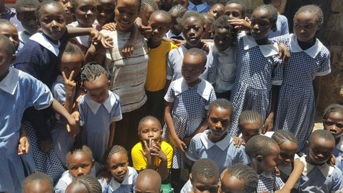 Grace Nkundabantu, a former refugee who fled the Democratic Republic of Congo, with some of the 120 orphans that she is funding through her foundation, the African Girls Hope Foundation. Photo courtesy of African Girls Hope Foundation
