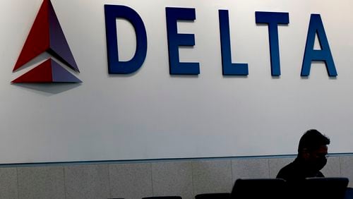 FILE - A man waits for a Delta Air Lines flight at Hartsfield-Jackson International Airport in Atlanta, Jan. 7, 2022. (AP Photo/Charlie Riedel, File)