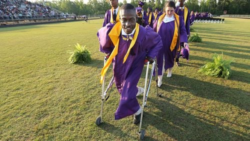 Devon Berry leads his class off the field at the conclusion of the ceremony at Hampton High School on Friday, May 27, 2016, in Hampton. Curtis Compton/ccompton@ajc.com