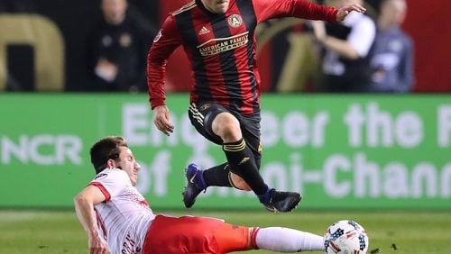 Atlanta United’s Greg Garza makes a move past N.Y. Red Bulls defender Alex Muyl during the first half of their first game in franchise history, March 5. (Curtis Compton/ccompton@ajc.com)