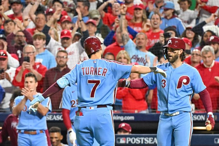 Philadelphia Phillies’ Trea Turner (7) celebrates with Bryce Harper (3) after a solo home run against the Atlanta Braves during the fifth inning of NLDS Game 4 at Citizens Bank Park in Philadelphia on Thursday, Oct. 12, 2023.   (Hyosub Shin / Hyosub.Shin@ajc.com)