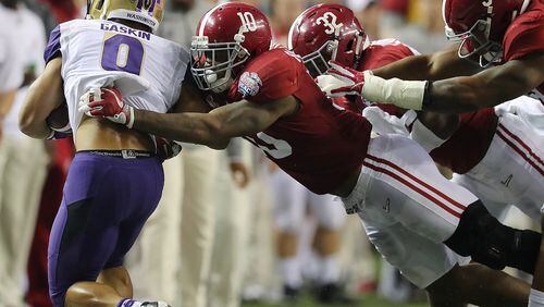 Washington tailback Myles Gaskin  is knocked out of bounds by Alabama defenders  in the 2016 Chick-fil-A Peach Bowl on Dec. 31 in Atlanta. The Crimson Tide won the game. Curtis Compton/ccompton@ajc.com