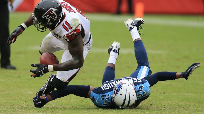 102515 NASHVILLE: -- Falcons wide receiver Julio Jones can’t hold on after the collision with Titans cornerback Coty Sensabaugh during the second half in a football game on Sunday, Oct. 25, 2015, in Nashville. Curtis Compton / ccompton@ajc.com