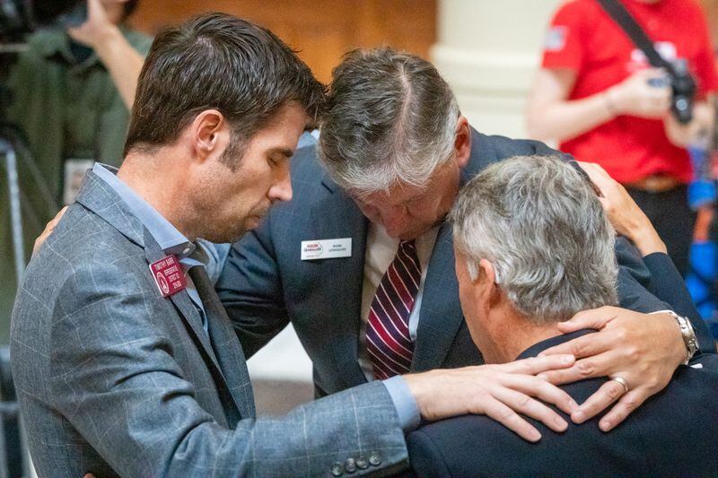 People gather in small groups to pray during an anti-abortion press conference in the state capital Friday, May 6, 2022. (Steve Schaefer / steve.schaefer@ajc.com)