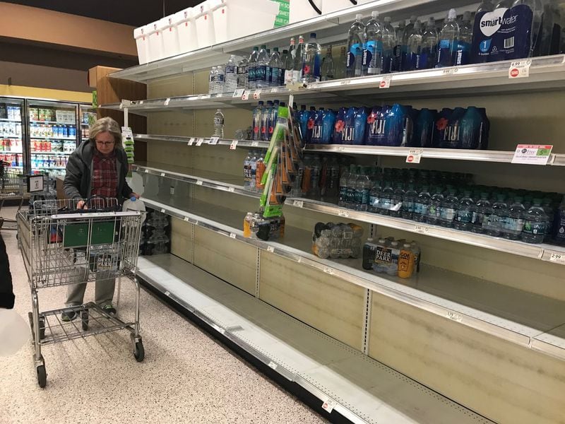 Shoppers at Publix at Town Brookhaven purchased the majority of bottled water on the normally well-stocked shelves.  LIGAYA FIGUERAS / LIGAYA.FIGUERAS@AJC.COM