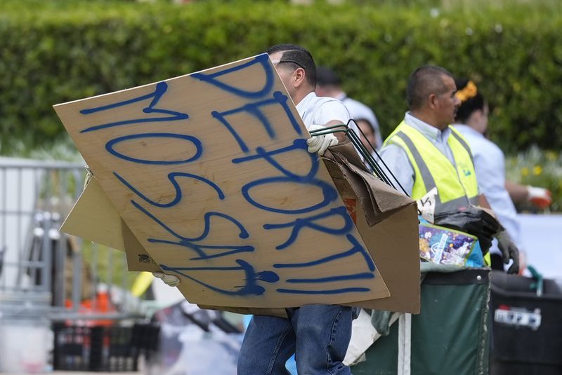 A sign is removed at the site of a pro-Palestinian encampment which was cleared by police overnight on the UCLA campus Thursday, May 2, 2024, in Los Angeles. (AP Photo/Ashley Landis)