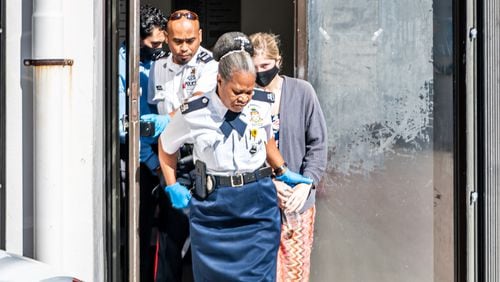 Vanjae Ramgeet and Skylar Mack being led out of the courthouse on their way to prison after sentencing at George Town Court House.  Skylar Mack (18), who is a medical student in the US, and local competitive Jet Ski rider Vanjae “VJ” Ramgeet (24) have both been sent to jail for four months for breaching isolation rules.   Taneos Ramsay / Cayman Compass 