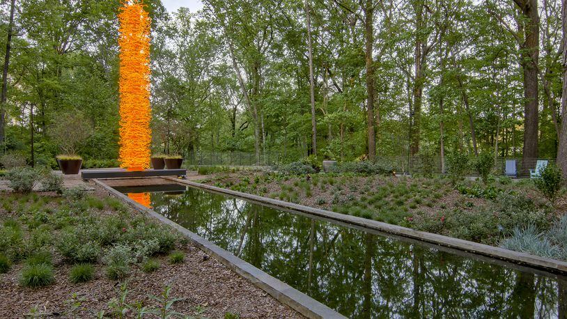 Chihuly's "Saffron Tower" sits in the Storza Woods section of the Atlanta Botanical Gardens. CONTRIBUTED: ATLANTA BOTANICAL GARDEN