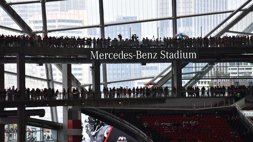 Falcons fans  walk inside the new Mercedes-Benz Stadium before an exhibition game against the Arizona Cardinals on Saturday, August 26, 2017. HYOSUB SHIN / HSHIN@AJC.COM