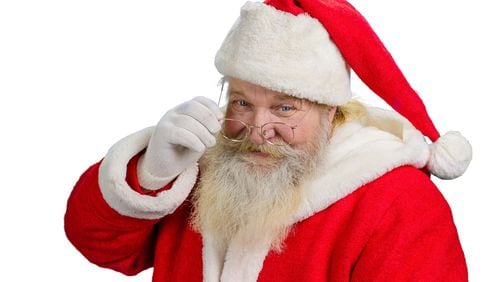 Santa Claus removing his glasses. Portrait of cheerful Santa Claus isolated on white background close up. Santa Clause tuching his eye glasses.