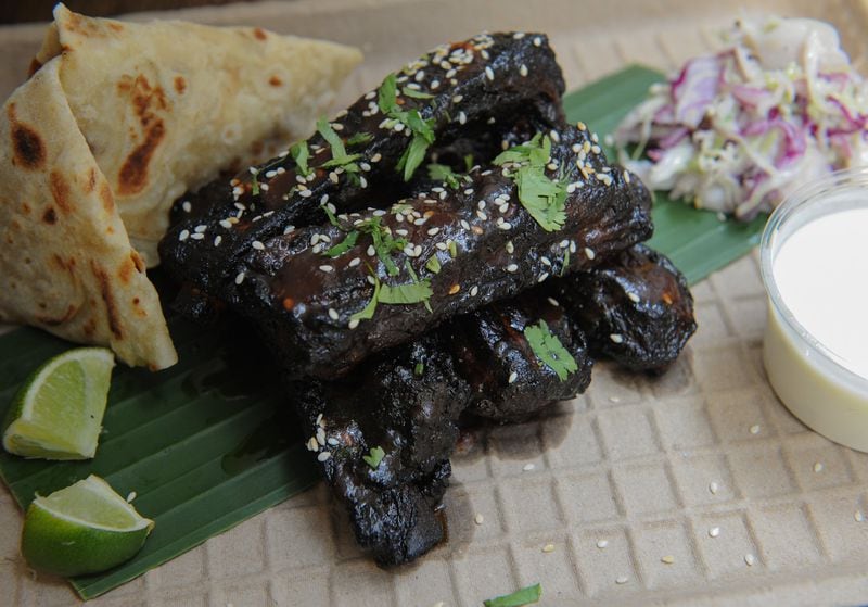Tamarind Glazed Spare Ribs are desi-style pork ribs braised with ginger,garlic, soy, star anise and finished with tamarind-ginger glaze, scallions and toasted sesame seeds. Served with desi slaw , raita and parathas. (Beckysteinphotography.com)