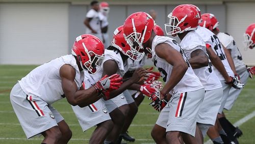Georgia defensive players run through drills on the first day of spring football practice Tuesday, March 21, 2017, in Athens.