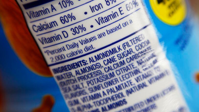 This Thursday, Feb. 16, 2017, photo shows the ingredients label for almond milk at a grocery store in New York. Dairy producers are calling for a crackdown on the almond, soy and rice "milks" they say are masquerading as the real thing and cloud the meaning of milk for shoppers. A group that advocates for plant-based products has countered by asking the Food and Drug Administration to say foods can use terms such as "milk" and "sausage," so long as they're modified to make clear what's in them. (AP Photo/Patrick Sison)