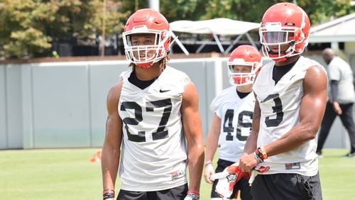 Georgia defensive backs Eric Stokes (27) and Tyson Campbell (3) wait their turns during a drill in the Bulldogs' practice session Saturday, Aug. 3, 2019, on the Woodruff Practice Fields in Athens.