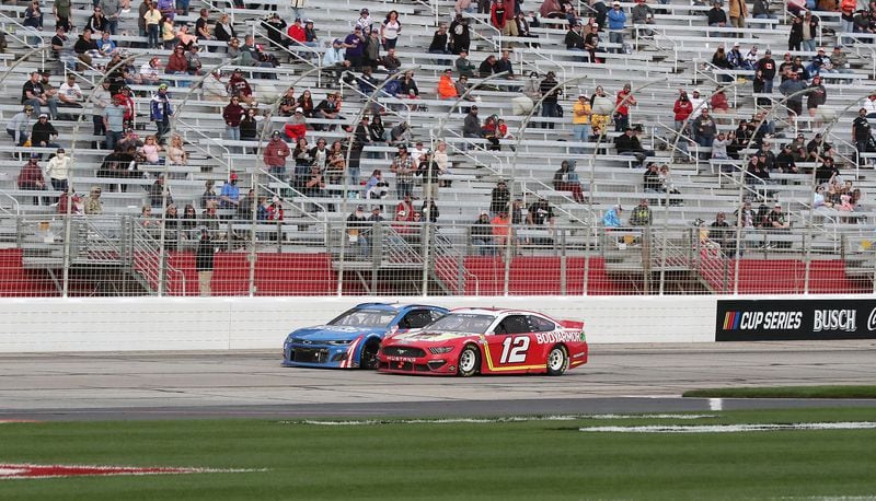 Ryan Blaney's No. 12 car passes Kyle Larson with eight laps remaining on his way to winning the Folds of Honor QuikTrip 500 Sunday, March 21, 2021, at Atlanta Motor Speedway in Hampton. (Curtis Compton / Curtis.Compton@ajc.com)