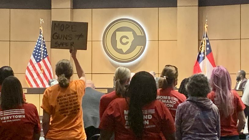 The Cobb County school board approved a new set of rules that prohibits public commenters from disrupting meetings. A Cobb school board vote on Thursday, July 14, 2022, to adjust which school employees can be armed drew protesters who opposed the change and wanted the vote postponed. They chanted "Delay the vote" for about 10 minutes, but the board approved the new policy anyway. (Cassidy Alexander / Cassidy.Alexander@ajc.com)