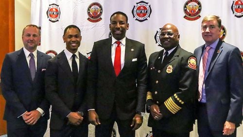 During a Breakfast with Our Bravest event, Atlanta Fire Rescue Foundation Board Chair Chris Sizemore (from left), Atlanta Fire Rescue Foundation president and CEO Taos Wynn, Atlanta Mayor Andre Dickens, Atlanta Fire Rescue Department chief Roderick M. Smith and Atlanta Track Club CEO Rich Kenah announced a new 5K race to benefit firefighters.