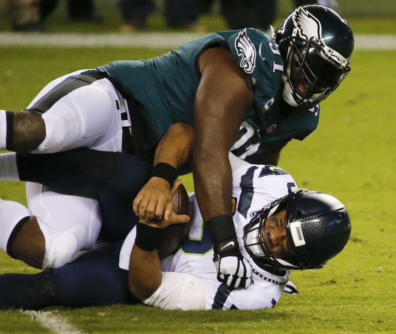 Philadelphia Eagles defensive tackle Fletcher Cox takes down Seattle Seahawks quarterback Russell Wilson during the first quarter on Monday, November 30, 2020. (Monica Herndon/The Philadelphia Inquirer/TNS)