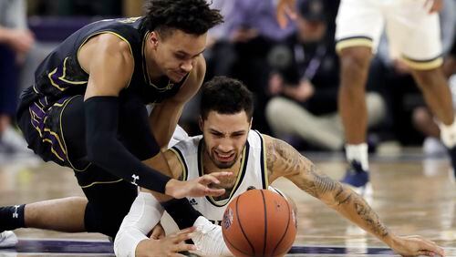Northwestern forward A.J. Turner, left, and Georgia Tech guard Jose Alvarado battle for a loose ball during the first half of an NCAA college basketball game, Wednesday, Nov. 28, 2018, in Evanston, Ill. (AP Photo/Nam Y. Huh)