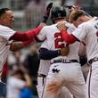 Atlanta Braves' Austin Riley (27) celebrates his walk-off RBI-single for the win in the 10th inning of a baseball game against the Cleveland Guardians, Sunday, April 28, 2024, in Atlanta. (AP Photo/Mike Stewart)