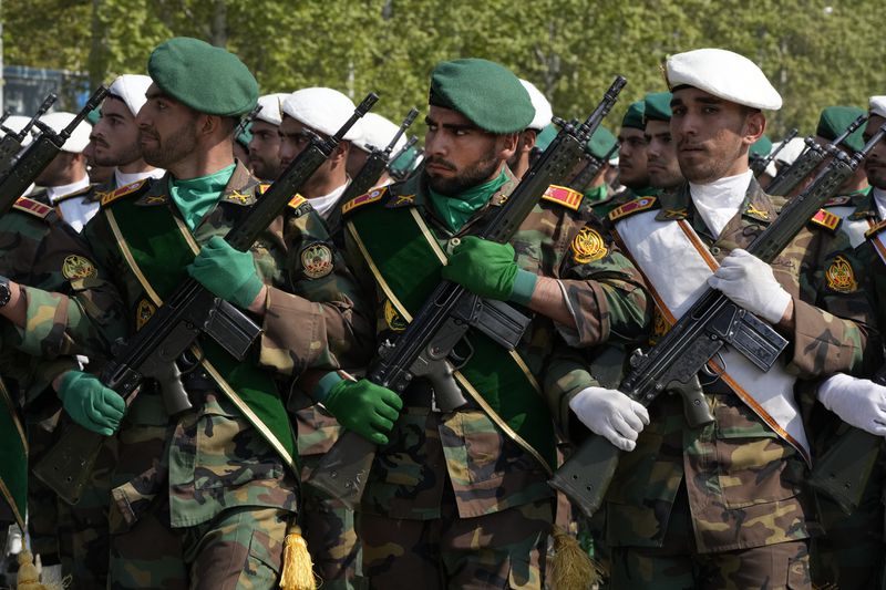 Iranian army members march during Army Day parade at a military base in northern Tehran, Iran, Wednesday, April 17, 2024. In the parade Iran's President Ebrahim Raisi warned that the "tiniest invasion" by Israel would bring a "massive and harsh" response, as the region braces for potential Israeli retaliation after Iran's attack over the weekend. (AP Photo/Vahid Salemi)