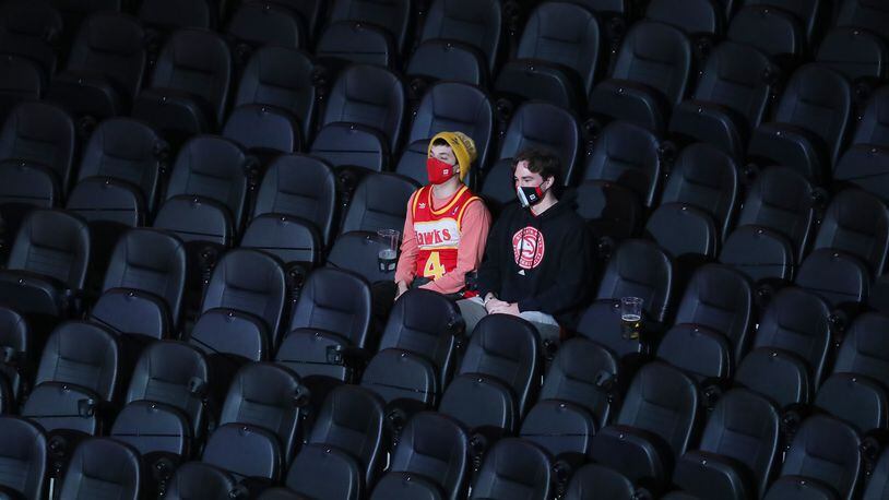 122820 ATLANTA: The seats are mostly empty with the exception of a few guests while the Atlanta Hawks play their home opener against the Detroit Pistons in a NBA basketball game on Monday, Dec. 28, 2020, in Atlanta.  “Curtis Compton / Curtis.Compton@ajc.com”