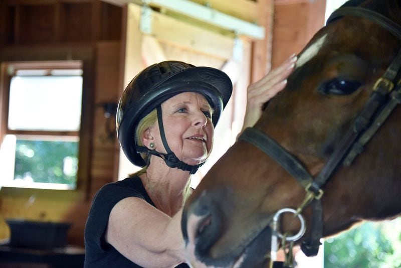 Robin Chisolm-Seymour’s love of horses began as a child. While she dealt with hearing loss, losing her skill at horseback riding was painful, and she worked to regain it. HYOSUB SHIN / HSHIN@AJC.COM