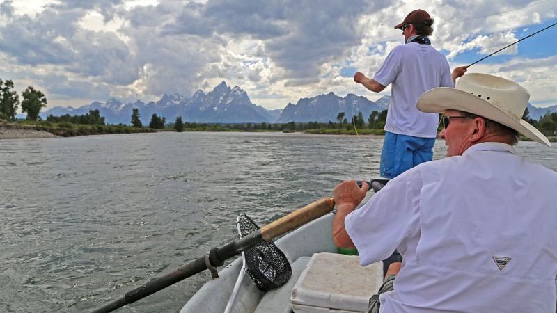 Dennis Anderson, foreground, rows the Snake River in Grand Teton National Park while his son, Trevor, casts. (Dennis Anderson/Minneapolis Star Tribune/TNS)