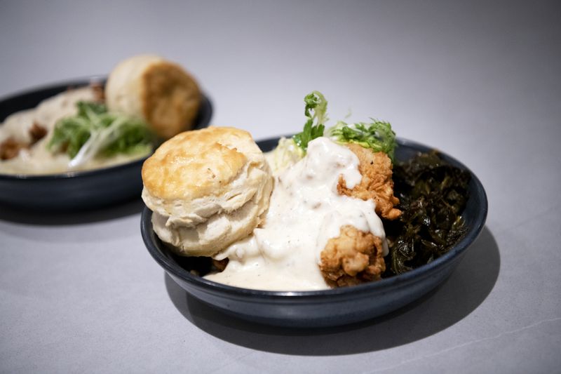 Smoked fried chicken with collared greens, gravy and a biscuit is a fixture on the menu at all Café Momentum locations. Courtesy of Café Momentum 