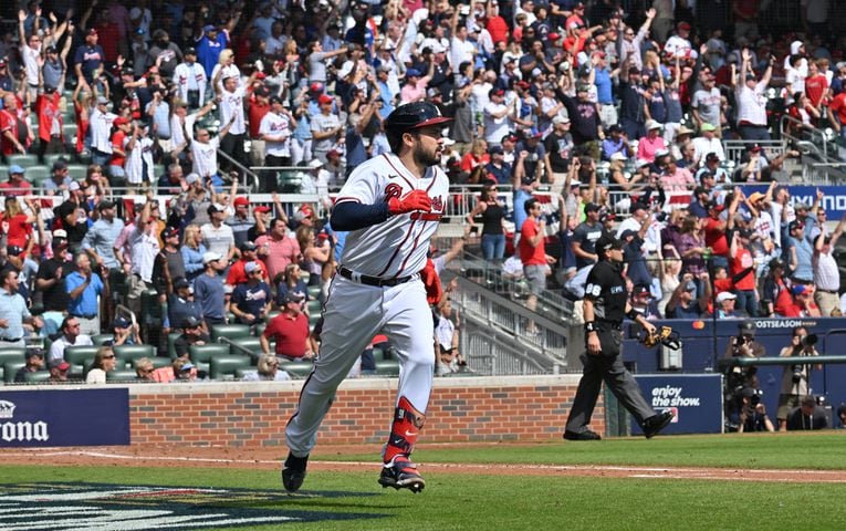 Atlanta Braves' Travis d'Arnaud hits a solo home run during the second inning of game one of the baseball playoff series between the Braves and the Phillies at Truist Park in Atlanta on Tuesday, October 11, 2022. (Hyosub Shin / Hyosub.Shin@ajc.com)