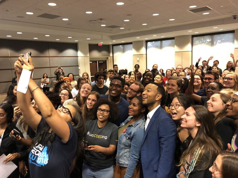 Singer-songwriter John Legend takes a selfie with Georgia Tech students during a visit to boost Democrat Stacey Abrams’ campaign for governor.
