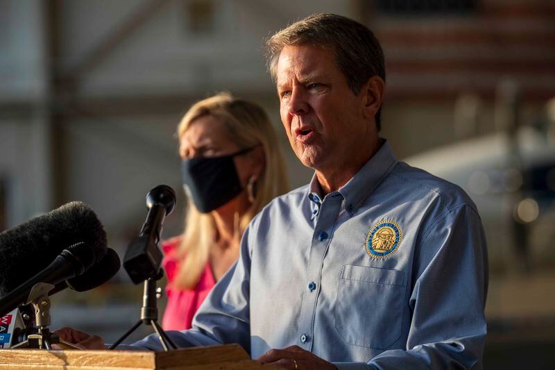 Gov. Brian Kemp speaks Friday during a press conference at DeKalb-Peachtree Airport in Atlanta. The governor and first lady Marty Kemp went on a fly-around tour of Georgia, encouraging Georgians to take precautions to stem the spread of the coronavirus. (Alyssa Pointer / Alyssa.Pointer@ajc.com)