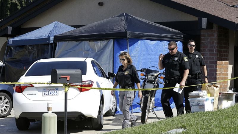 Sacramento County sheriff's deputies are pictured Wednesday, April 25, 2018, outside the home of Joseph James DeAngelo Jr. in Citrus Heights, California. DeAngelo, a 72-year-old former police officer, was arrested Tuesday, April 24, 2018, and accused of being the Golden State Killer, a serial killer and rapist responsible for at least 12 murders and 45 rapes throughout California in the 1970s and 1980s. Over four decades, the elusive killer was also known as the East Area Rapist and the Original Night Stalker.