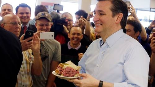 FILE - In this April 21, 2016 file photo, Republican presidential candidate, Sen. Ted Cruz, R-Texas, holds his sandwich during a campaign stop at Shapiro's Delicatessen, in Indianapolis. (AP Photo/Darron Cummings, File)