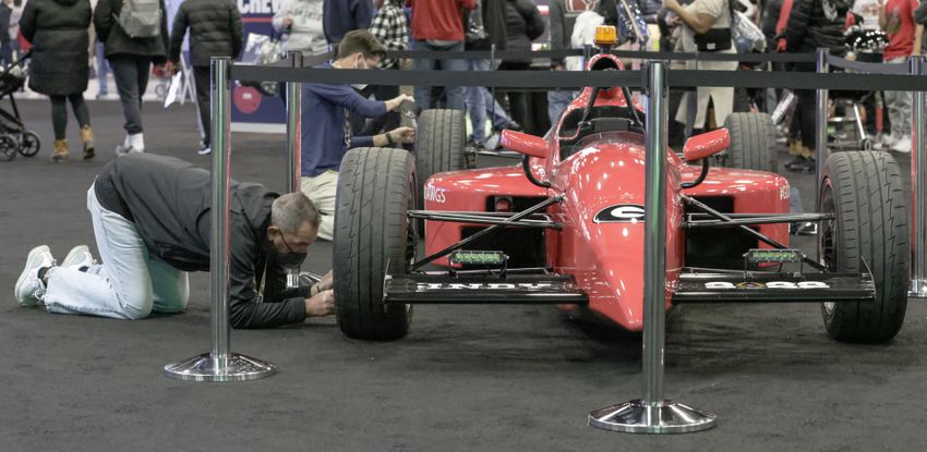 Jeff Church makes some adjustments to a Georgia-themed Indy car at Fan Central in the Indiana Convention Center at the 2022 College Football Playoff National Championship  between the Georgia Bulldogs and the Alabama Crimson Tide at Lucas Oil Stadium in Indianapolis on Saturday, January 8, 2022.   Bob Andres / robert.andres@ajc.com